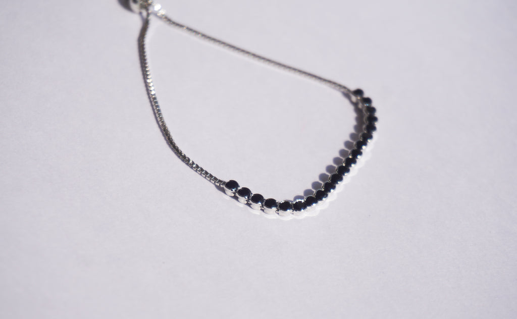 Pulsera tennis plateada con zirconias negras