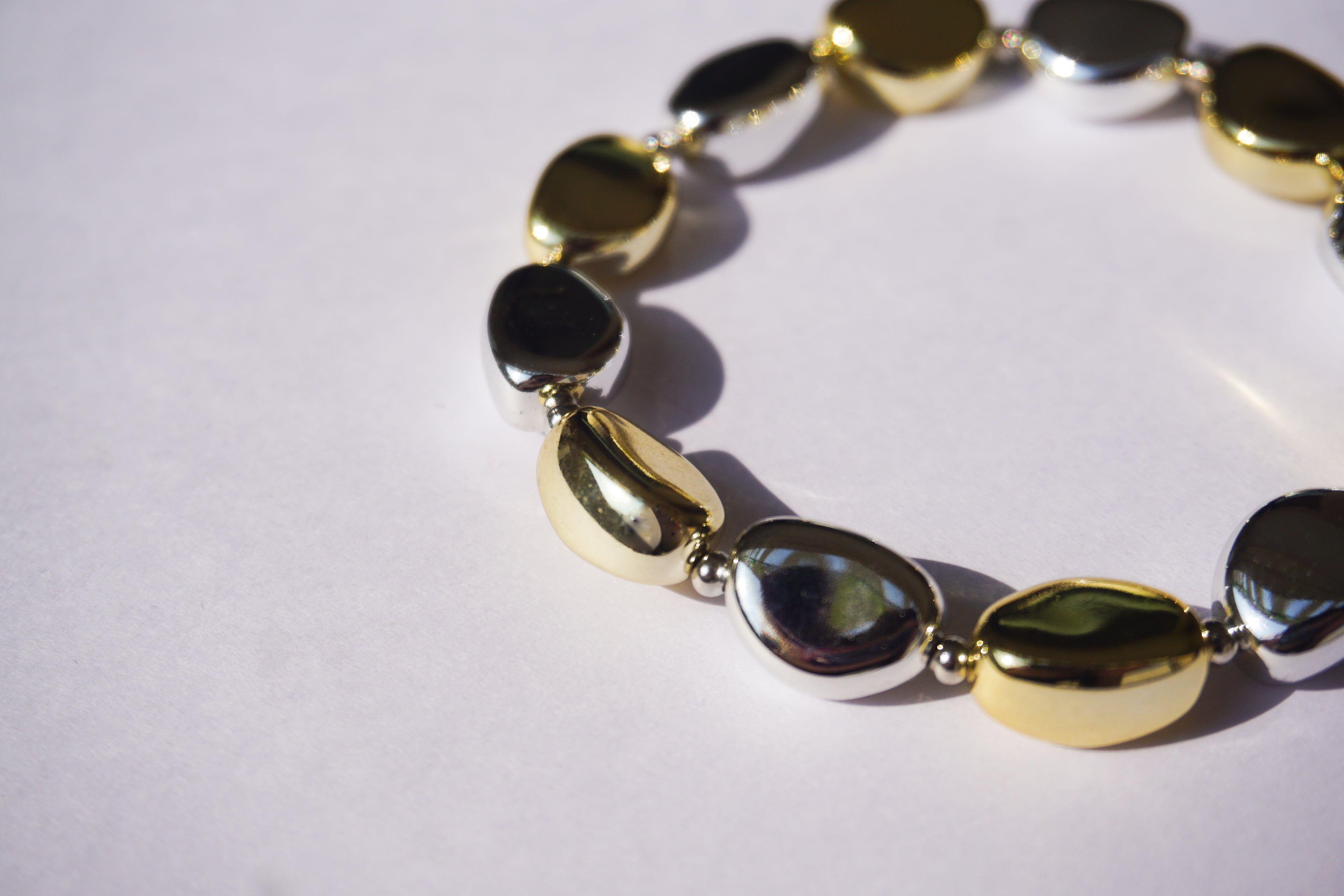 Pulsera de piedras de plástico doradas y plateadas intercaladas