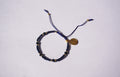 Pulsera de hilo azul con cristales y San Benito dorado
